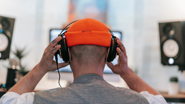person listening to headphones with phono preamp
